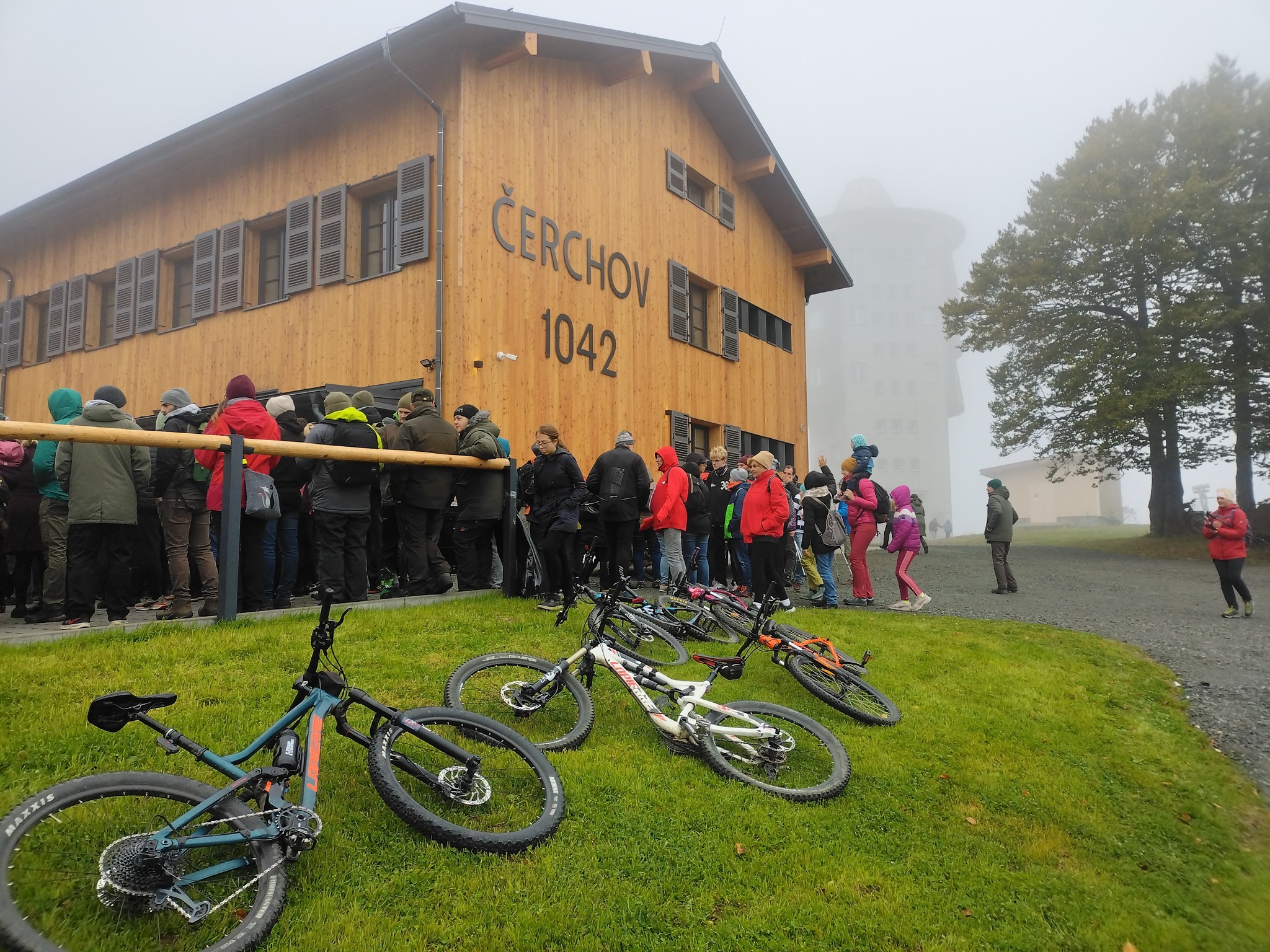 nová horská chata na Čerchově v mlzem v popředí jízdní kola